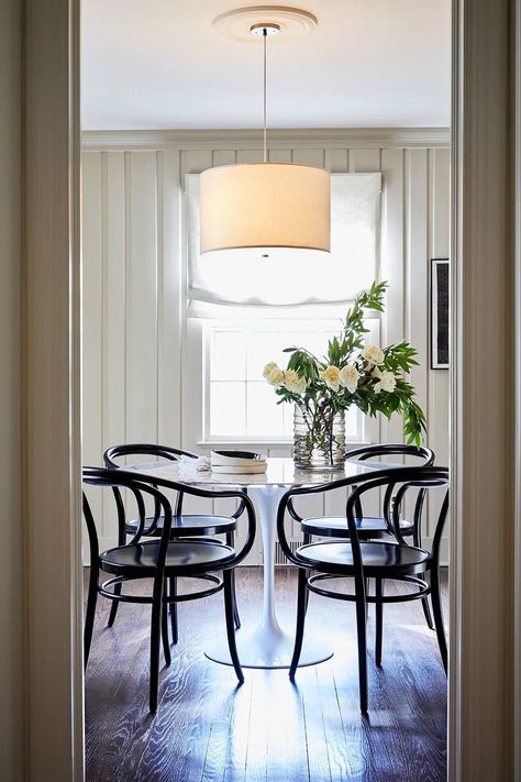 A mix of modern and antique finds decorate the dining room. Black Cane Chair, Nyc Couple, Saarinen Dining Table, White Shag Rug, House Styling, Cane Chair, Bentwood Chairs, Dining Nook, Dining Room Walls