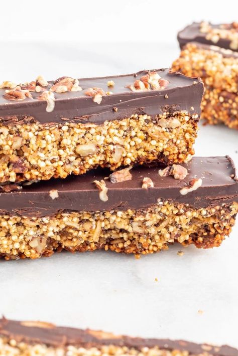 Load up on all good things with these crunchy quinoa chocolate superfood bars containing a healthy mix of chia seeds, flaxseeds, oats, quinoa, nuts, coconut oil, and of course chocolate. These yummy bars are naturally vegan, gluten-free, egg-free, and free from refined sugars. Make a big batch and keep stored in the freezer for when that sweet tooth strikes. Salty Gluten Free Snacks, Quinoa Protein Bar, Popped Quinoa Crunch Bars, Chocolate Quinoa Crunch Bars, Quinoa Bars Healthy, Thistle Recipes, Kind Bars Recipe, Healthy Nut Bars, Quinoa Crunch Bars