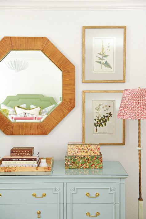 Wicker mirror next to two botanical pieces of framed artwork above light blue dresser with book and nest toe a floor lamp. Grandmillenial Interiors, Dresser Styling Bedroom, Owners Bedroom, Style A Dresser, Dresser Styling, Grandmillenial Style, Grand Millennial, Beautiful Dresser, Furniture Trends