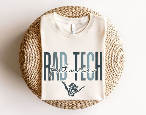 "This \"Future RAD Tech\" shirt would make the perfect gift for radiology school students who are working to be a x-ray tech! Want this in a sweatshirt instead? You can find it here: https://www.etsy.com/listing/1458465415 *HOW TO ORDER* 1. Look through photos at the different colors and the sizing chart (all shirts & sweatshirts are unisex!) 2. Select your size and color from the drop down menus. 3. Choose the quantity you want in that size and color. 4. If applicable, add your custom wording u Xray Tech Sublimation, Radiology Tech Shirts, Funny Rad Tech Memes, Rad Tech Student, Radiology Schools, Mri Technologist, Rad Tech Shirt, Radiology Gift, Radiology Shirts