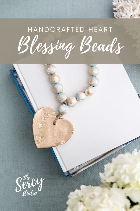 The Nancy blessing beads with a gold heart pendant is laying across a stack of books. Blessing Beads Meaning, Blessing Beads, A Stack Of Books, Keepsake Gifts, Gold Cross Pendant, Stack Of Books, Gold Accent, Gold Cross, Keepsake Gift