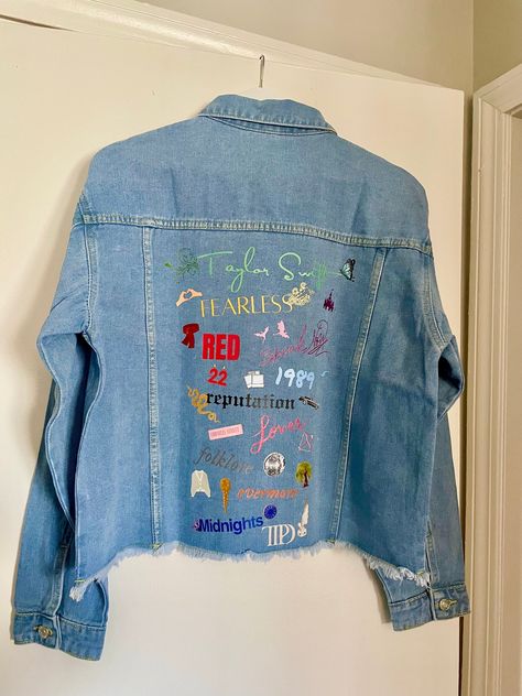 Stay in style with this classic medium wash denim jacket, customized to celebrate all of Taylor's iconic eras. Featuring images representing each album and various songs. Women's Jean Jacket Frayed Washed Button Up Cropped Denim Jacket With Pockets 65% Cotton, 35% Polyester Stylish raw hem, two chest fake pockets, two side slant hand pockets, turndown collar, button cuffs Design is DTF heat transfer decal, hand pressed.  Variations and small imperfections may occur as it is a handmade product, each design pressed individually. Taylor Swift Eras Denim Jacket, Eras Tour Painted Jacket, Swiftie Jean Jacket, Taylor Swift Eras Jean Jacket, Lover Jean Jacket Taylor Swift, Taylor Swift Painted Jacket, Taylor Swift Jacket Diy, Taylor Swift Jean Jacket Diy, Eras Tour Jean Jacket