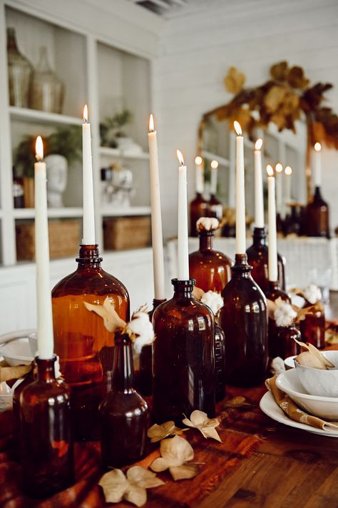 Fall Amber Bottle Centerpiece - Liz Marie Blog Industrial Farmhouse Centerpiece, Amber Fall Decor, Amber Jars Decor, Cottage Fall Aesthetic, Moody Fall Dinner Party, Cozy Fall Party, Fall Harvest Decor, Fall Inspiration Decor, Fall Table Centerpieces For Home