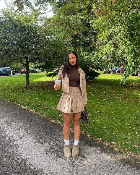 Khaki Skirt Outfit Winter, Uggs And Mini Skirts, Tan Pleated Skirt Outfit, Khaki Pleated Skirt Outfit, Brown Pleated Skirt Outfit, Tan Skirt Outfit, Tan Skirt Outfits, Khaki Skirt Outfit, Leather Motorcycle Jacket Outfit