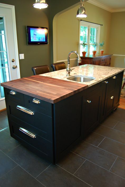 Walnut butcher block. Island with black painted cabinets and nickel cup pulls. Prep sink in Delicatus granite. Butcher Block And Granite Island, Butcher Block Granite Combo, Tiled Kitchen Island Top, Granite And Butcher Block Countertops, Black Island With Butcher Block, Butcher Block And Granite Countertops, Black Butcher Block, Black Painted Cabinets, Butchers Block Island