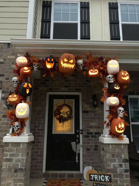 We made the garland with PVC pipe, some leaf garlands from craft stores, halloween string lights, and foam pumpkins! We cut and assembled the PVC to fit our columns and then painted it black. Next we spent a few hours carving our pumpkins while watching scary movies! Then we laid all the pumpkins out and decided how we wanted them arranged. Once we were happy with that, we super glued the leaves Halloween Decor Columns, Column Garland Christmas, Halloween Decorations Outdoor Lights, Halloween Pumpkin Outdoor Decor, Scary Movie Halloween Decorations, Porch Pillar Halloween Decor, Halloween Decoration Themes Outdoor, Halloween Column Decor, Diy Halloween Columns