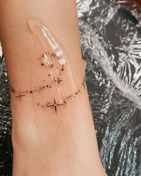 Stars Around Wrist Tattoo, Space Bracelet Tattoo, Stars Around Moon Tattoo, Space Arm Band Tattoo, Celestial Arm Band Tattoo, Black And Brown Tattoo, Stars Wrapped Around Arm Tattoo, Milky Way Tattoos, Sun Arm Tattoos For Women