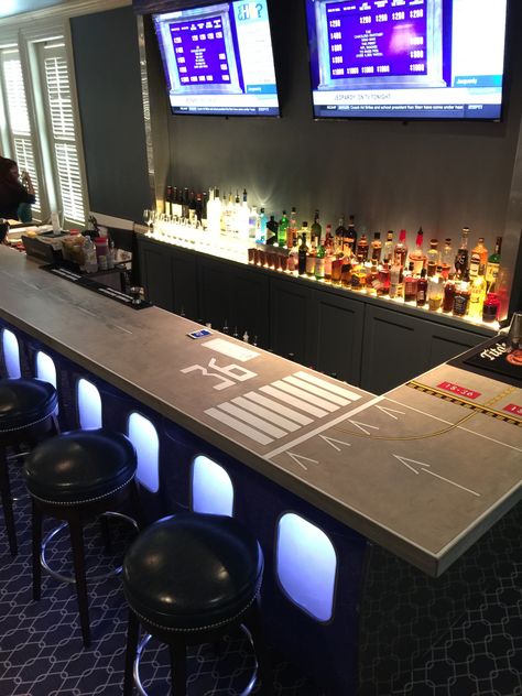 Airport themed bar with runway printed bar top. Aviation Bar Ideas, Airplane Hanger Man Cave, Aviation Themed Bar, Aviation Man Cave, Aviation Decor Interior Design, Pilot Lounge, Aviation Bar, Military Bar, Aviation Office