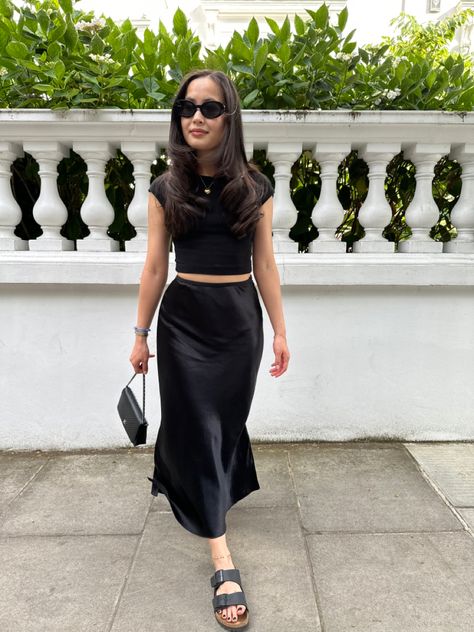 Satin Midi Skirt Outfits Party, Long Silk Skirt Outfit Casual, Black Midi Skirt Outfit Summer Casual, Silky Midi Skirt Outfit, Midi Black Skirt Outfit Summer, Black Long Silk Skirt Outfit, Long Black Skirt Outfit Party Night, Black Long Satin Skirt Outfit, Satin Skirt Black Outfit