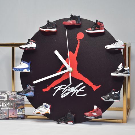 Clock size is 12 inches in diameter. Come with 12 different popular(OG) AJ Retro mini sneakers All mini sneakers are relocatable, it's stick to the clock base with a magnet. Require AA Battery. SPECIFICATIONS: *Material: MDF (body) & PVC (shoes)  *Size: 12 inches *Clock Mechanism INSTALLATION: 1. Find the little Circle sticker that came with the package, places it into the clock hours location where the white dot indicated. 2. Remove the double side tape and put the magnet on top. 3.Insert the M Jordan Clock, Basketball Centerpieces, Michael Jordan Sneakers, Baskets Jordans, Mens Bedroom Decor, Jordan Sneaker, Shoes Sneakers Jordans, Sneaker Lovers, Air Jordan 1 Mid