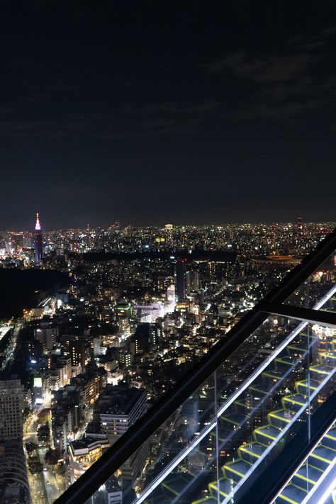 Shibuya Sky rooftop sits on top of the Scramble Square shopping mall in the heart of Shibuya, and is definitely the BEST VIEW OF TOKYO.   It's also brand new - the 47-storey building only opened in November 2019!   I made a video on it which you can watch here! On Top Of Building Aesthetic, Rooftop Building Night, Shibuya Night Aesthetic, Shibuya Sky Aesthetic, Shibuya Sky Night, Rooftop View Night Aesthetic, Sitting On Top Of Building, Sitting On Rooftop Aesthetic Night, Tokyo City Night Aesthetic