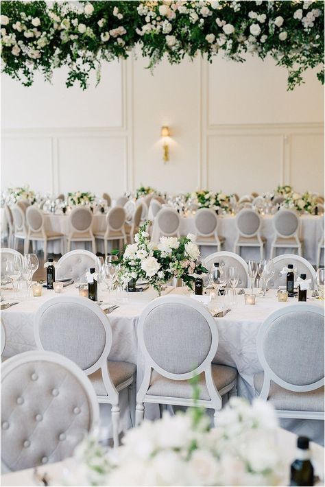 long dining tables, rectangle wedding tables, indoor ballroom wedding ceremony, modern elegant romantic wedding deocr, white and grey wedding, gray wedding decor, floral ceiling installation, white and grey wedding chairs, sweetheart table, The Arlington Estate wedding photos, Toronto wedding planner Laura Olsen Events planned and designed this stunning and romantic Vaughan wedding venue The Arlington Estate, ontario vineyard wedding, toronto wedding planner Wedding Reception Chairs, Niagara Wedding, Modern Wedding Venue, Purple Tree, Modern Minimalist Wedding, Purple Trees, Venue Decor, Ballroom Wedding, Wedding Decor Elegant