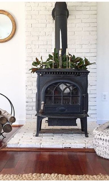 White Wood Burning Stove, Black Brick Wood Stove Hearth, Tile Under Wood Burning Stove, White Brick Hearth Wood Stove, Wood Stove White Brick, Hearth Wood Stove, Tile Behind Woodstove, Wood Burning Stove Feature Wall, Woodstove Hearths Brick