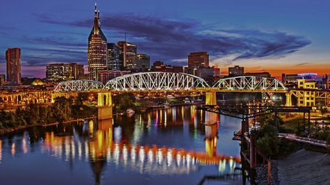 Twilight settles over the Cumberland River and downtown Nashville. Nashville 2023, Nashville Tours, Skyline Wallpaper, Nashville Skyline, Visit Nashville, Nashville Trip, Downtown Nashville, Tour Bus, Grand Ole Opry