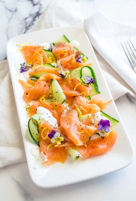 This smoked salmon and cucumber salad is an easy and quick way to serve up an impressive appetizer. With just 5 ingredients it takes minutes to prepare and looks amazing on a platter or plate. Perfect for summer BBQ's or for summer pot lucks. Serve it with some crostini or crusty bread and people can make their own delicious smoked salmon salad bruschetta. Serve it individually plated as an elegant dinner party appetizer, or box it up and have it on a picnic with your family and friends. Smoked Salmon Starters For Dinner Party, Smoked Salmon And Cucumber, Salmon And Cucumber, Smoked Salmon Platter, Salmon Platter, Smoked Salmon Appetizer, Dinner Party Appetizers, Salmon Appetizer, Smoked Salmon Salad