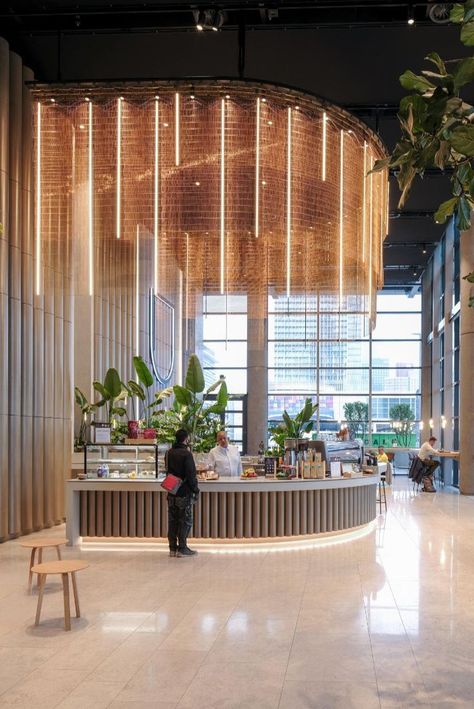 a man stands at the bar of the world port center rotterdam surrounded by green plants Circle Room Design, Event Room Design, Lobby Area Design, Circle Interior Design, Circle Room, Layered Curtains, Event Room, Counter Design, Lobby Design