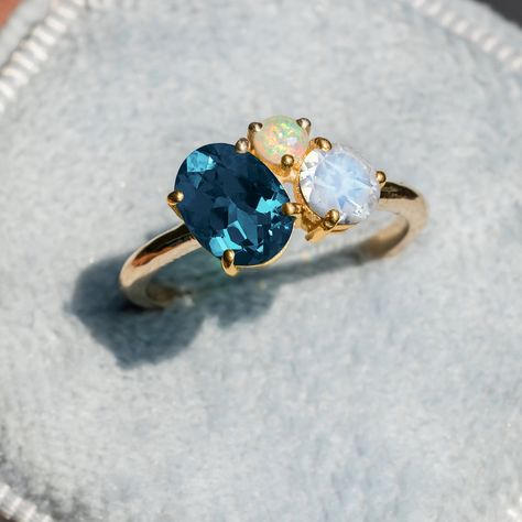 "Toi Et Moi Ring/Multi Stone Ring/Topaz Opal Moonstone Ring/London Blue Ring/Moonstone & Opal Ring/Three Stone Ring/Cluster Engagement Ring ★ ★ ★ ★  CUSTOM/DUTY-FREE SHIPPING WORLDWIDE, BUYERS DON'T HAVE TO PAY ANY CUSTOM FEES WHILE IMPORTING ★ ★ ★ ★  Details Made to order Material: 14k/18k Gold Color Options: Yellow Gold, White Gold, Rose Gold ★ Stone 1 London Blue Topaz, Oval Cut Size: 6x8mm Approx Weight (Ct): 1.29 ★ Stone 2 Moonstone, Round Size: 5mm  Approx Weight (Ct): 0.585 ★ Stone 3 Opal, Round Size: 3mm  Approx Weight (Ct): 0.14 ★ 100% Natural Diamond and Gemstones ★ Diamond: Round Brilliant cut, G-H Color, SI Clarity ☂ Shipped with Insured Shipping with 4-7 business days. ➦ 100% Free Returns. ➦ Our Jewelry comes with a Lifetime Warranty. (Stone Replacement not included) ✈ We offe Cluster Stone Ring, Opal Moonstone, Ring Three Stone, Ring Cluster, Ring Moonstone, Multi Gemstone Ring, Diamond Cluster Engagement Ring, Blue Ring, Three Stone Ring