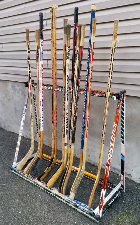 Hockey Stick Rack Diy, Hockey Stick Holder Diy, Hockey Stick Rack, Hockey Stick Storage, Hockey Stick Furniture, Hockey Stick Crafts, Backyard Hockey Rink, Hockey Organization, Jersey Hanger