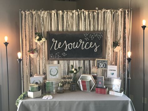 Resource and book table at Summit Women's Conference 2017. Ribbon backdrop. Hanging plants. Chalkboard. Table display. Conference Display, Expo Tables Display Ideas, Book Table Display, If Gathering 2023, Womens Conference Backdrop, Women's Conference Decor, Book Display Table, Ladies Conference Decor, Women Conference Ideas Decor