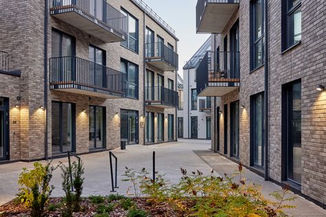 The main idea of the multi-apartment building complex was to create a cozy, old-town essence possessing a structure with courtyard spaces and a perimeter of two to three-story buildings with an attic. Courtyard Apartment Building, Apartment Building With Courtyard, Wooden Apartment Building, Brick Apartment Building, Apartment Complex Exterior Old, Courtyard Apartments, Urban Courtyards, Cambridge Uk, Brick Loft