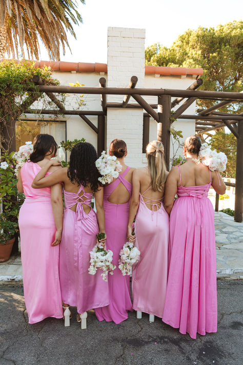 Shades of pink bridesmaid dresses with lace ups and fun straps! Shades Of Pink Satin Bridesmaid Dresses, Pink Dress Wedding Bridesmaid, All Different Pink Bridesmaid Dresses, All Shades Of Pink Wedding, Spring Pink Bridesmaid Dresses, All Pink Bridesmaids Dresses, Medium Pink Bridesmaid Dresses, Summertime Bridesmaid Dresses, Summer Pink Bridesmaid Dresses