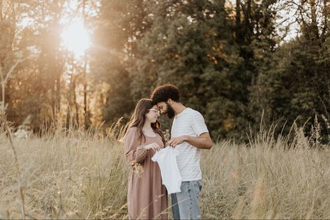 Man and woman forehead to forehead smiling holding up a white baby onesie in front of them Onesie Maternity Photos, Onsie Announcement Pregnancy, Pregnancy Announcement With Onesie, Onsie Announcement, Sonogram Pregnancy Announcement, Family Baby Announcement, Pregnancy Announcement Pictures, Announcement Pictures, Announcement Photoshoot