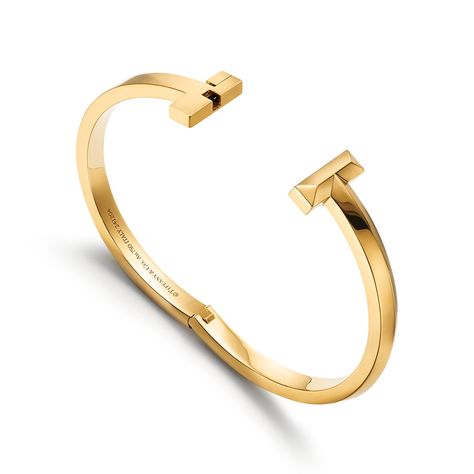 Tiffany T is an expression of love’s endless potential. Inspired by an archival bracelet from 1975, T is an homage to the House’s iconic motif and the spirit of New York, which founder Charles Lewis Tiffany regarded as the place of promise and possibilities. Stack this hinged bangle with other Tiffany T bracelets for a bold look, or simply wear it on its own. 18k gold; Size small; Fits wrists up to 5.75" | Tiffany T T1 Narrow Hinged Bangle Bracelet in Yellow Gold, Size: Small Gold Tiffany Bracelet, Tiffany Bracelet Stack, Tiffany Bracelet Gold, Tiffany Bangle, Tiffany Gold, Tiffany Bracelet, Endless Potential, Stacking Jewelry, Light Grey Leggings