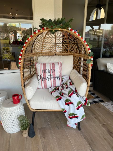 Spruce up your adorable egg chairs for the holidays! Possibilities are endless. Here, I started by adding the battery operated led string lights. Then layered two pine picks over the hand hole at top of chair, placed in opposite directions, for a base for the other decor. I then twisted together the wood bead strand and Eucalyptus garland and placed on the edge/lip of tbe chair. Secured with some green pipe cleaners. Have fun! I plan to do other holidays as well! Egg Chair Christmas Decor, Christmas Egg Chair, Egg Chair Christmas Photoshoot, Egg Chairs, Magic Photo, Rent House, Xmas 2022, Christmas Fireplace Decor, Christmas Shoot