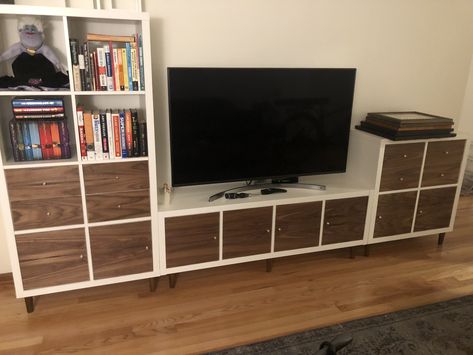 This is three Ikea Kallax units. I added legs from Prettypegs.com and covered the door and drawer front with walnut veneer I bought off Amazon.com. I also drilled a 2” hole for cable management so all the cables are well hidden. Ikea Kallax Tv Unit, Ikea Kallax Hack Tv Stands, Ikea Kallax Tv Stand, Kallax Tv Unit, Ikea Cube, Tv Hidden, Kallax Unit, Tv Setup, Ikea Kallax Unit