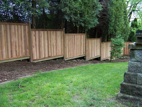 Building a fence on sloped ground is not that difficult, but there are a few things to consider. A pre-built wood fence would be “stair-stepped” down the slope… and quite easily f… Yard Fence Ideas, Wood Privacy Fence, Wood Fence Design, Sloped Yard, Yard Fence, Sloped Backyard, Pallet Fence, Fence Styles, Diy Fence