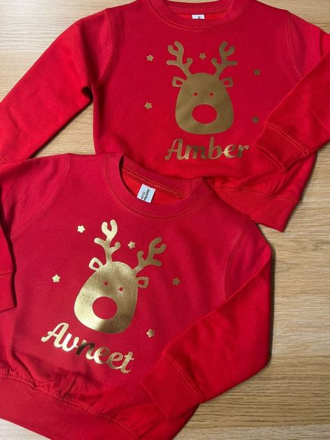 Personalised Christmas Jumper. Personalised With Metallic Gold Reindeer And Your Name. ~ ~ ~ ~ ~ ~ ~ ~ ~ ~ ~ ~ ~ ~ ~ ~ ~ ~ ~ ~ ~ ~ ~ ~ ~ ~ ~ NOT ALL COLOURS ARE LISTED, PLEASE ASK IF YOU WOULD LIKE A COLOUR FROM OUR CHART THAT IS NOT LISTED. ~ ~ ~ ~ ~ ~ ~ ~ ~ ~ ~ ~ ~ ~ ~ ~ ~ ~ ~ ~ ~ ~ ~ ~ ~ ~ ~ Childs: Age 3-4 - Chest (to fit): 26 Age 5-6 - Chest (to fit): 28 Age 7-8 - Chest (to fit): 30 Age 9-11 - Chest (to fit): 32 Age 12-13 - Chest (to fit): 34 Unisex Adults: X Small -  Chest (to fit): 34 Small - Chest (to fit): 36 Medium - Chest (to fit): 40 Large - Chest (to fit): 44 XL - Chest (to fit): 48 XXL - Chest (to fit): 52 3XL - Chest (to fit): 56 4XL - Chest (to fit): 60 5XL - Chest (to fit): 62 ~ ~ ~ ~ ~ ~ ~ ~ ~ ~ ~ ~ ~ ~ ~ ~ ~ ~ ~ ~ ~ ~ ~ ~ ~ ~ ~  PLEASE NOTE THAT WE DO NOT ACCEPT RETURNS Personalised Clothing, Jumper Ideas, Gold Reindeer, Xmas Jumpers, Cosy Jumper, Red Jumper, Cosy Night In, Christmas Sack, Christmas Jumper