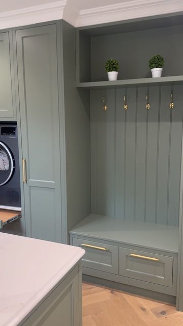 Trevor McDonnell Kitchens on Instagram: "The utility room at the “ Brookhill house project “  . . . We love the boot bench and the raised washer & dryer in this utility room. it made life for our clients so functional  . . A green utility room with raised washing machine and dryer combines practicality with a fresh, vibrant aesthetic. The green color palette, ranging from soft sage to rich emerald, infuses the space with a sense of calm and connection to nature.  The washing machine and dryer are elevated on sturdy platforms, making them easily accessible without the need to bend down, which enhances ergonomic convenience. These platforms often include built-in storage drawers underneath, perfect for housing laundry detergents, fabric softeners, and other cleaning supplies.  Cabinetry in c Utility Room Ideas Green, Cleaning Supply Storage Laundry Room, Sage Utility Room, Raised Washing Machine, Sage Laundry Room, Raised Washer Dryer, Green Utility Room, Utility Room Inspiration, Boot Bench