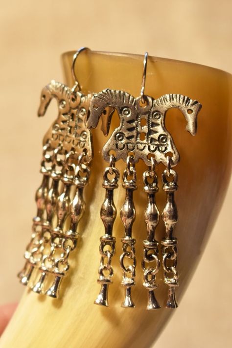 Long chandelier earrings - Viking double headed horses. Handmade sterling silver 925 or bronze earrings, inspired by ancient Norse jewelry. Great statement piece - bright but heavy earrings with charms. More about these earrings you can find in our Etsy shop SecretJewelryDesigns. #statementjewelry #vikingjewelry #horseearrings #handmadejewelry #statementearrings #animaljewelry #norsepaganjewel Norse Earrings, Viking Horse, Earrings With Charms, Long Chandelier, Norse Jewelry, Norse Pagan, Horse Earrings, Heavy Earrings, Unique Anniversary Gifts