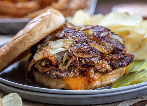 An Oklahoma Fried Onion Burger is two beef patties smashed down onto piles of fried onions and topped with cheese, on a toasted hamburger bun. Oklahoma Fried Onion Burger, Oklahoma Onion Burger, Sandwich Station, Baked Meals, Onion Burgers, Bbq Meats, Onion Burger, Honey Barbecue, Bbq Dishes