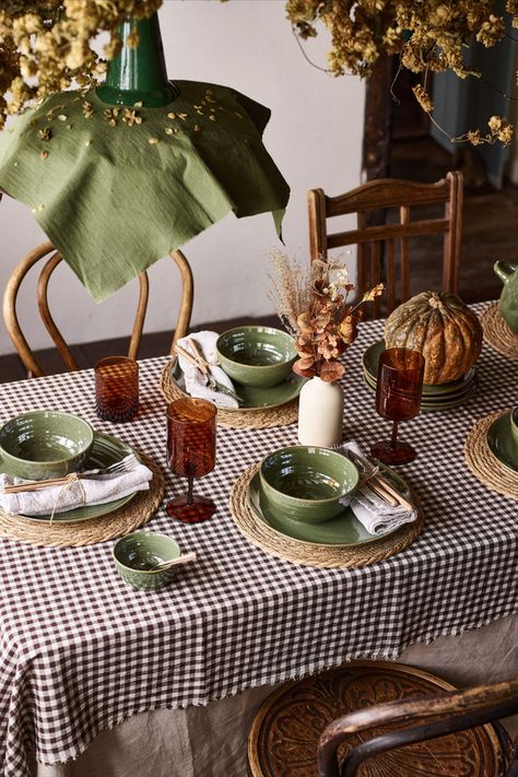 A fall-themed tablescape with a gingham tablecloth, pumpkins, and a garland of hops. Rich autumn colours create a warm and inviting Halloween home decor setting. Autumn Table Decorations, Autumn Decor Ideas, Gingham Tablecloth, Ready For Autumn, Autumn Table, London Design Festival, Fall Table Decor, Warm Colour Palette, Green Rooms