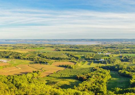 A panoramic shot is taken of the Annapolis Valley. Green hills and trees make up the forefront of the photo. Annapolis Valley, Bay Of Fundy, Summer Staycation, Spring Spa, Atlantic Canada, Old Orchard, Golf Resort, Boat Tours, Nova Scotia