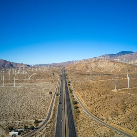 An aerial view of Highway 10, with the iconic windmills, is enough for us to start planning another trip to Palm Springs. 💙 📷 Kirk Wester Palm Springs Windmills, California Desert, Aerial View, Palm Springs, Places Around The World, Railroad Tracks, Filmmaking, Solar, California