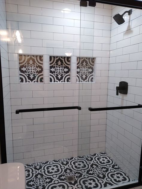 Shower Tile Designs Black And White, White Tile Shower With Dark Grout, Cementina Black And White Tile, Bathroom Vanity Accent Wall Ideas, White Shower Tile Grout Ideas, Black And White Restroom Tile, Tile Shower Black And White, Black And White Tile With Black Grout, White Shower With Black Accent Tile