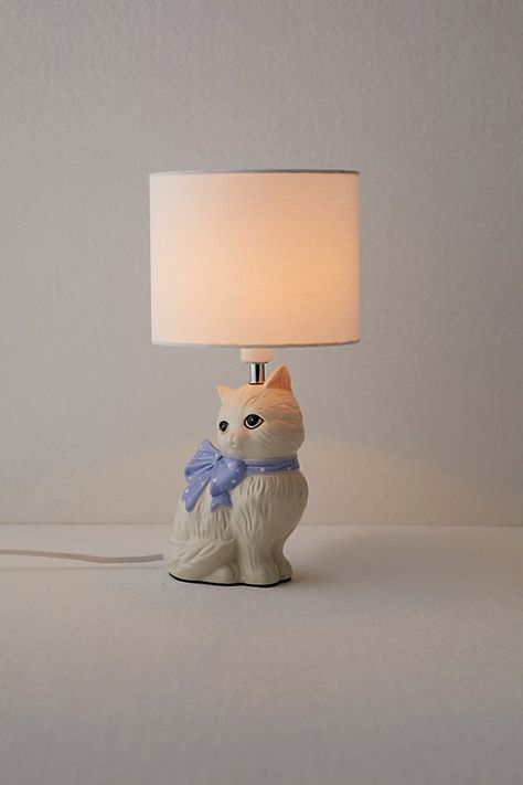 Add a charming, vintage-inspired touch to your space with our Adelaide Cat Table Lamp. This fun table lamp features a ceramic cat sculpture at the base with a woven drum shade at the top. Available exclusively at Urban Outfitters. Features Adelaide Cat Table Lamp from UO Home A fun ceramic table lamp with a cat base Woven drum shade Plug in Requires one E12 C-Type 25W bulb - not included UO exclusive Content + Care Ceramic, PVC, fabric Wipe clean Imported Made in compliance with US electrical st Urban Outfitters Decor, Girly House, Kitsch Cat, Cat Table, Rooms Decoration, Artist Study, Cat Sculpture, Uo Home, Study Ideas