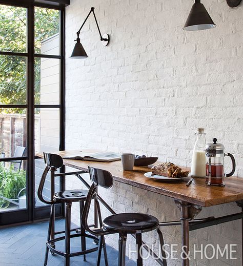 Two designers weigh in on iron doors and windows. | Photographer: Donna Griffith Painted Brick Interior Wall, Painted Brick Interior, White Brick Interior, Brick Veneer Wall, Painted Brick Wall, Spec House, Kitchen Design Black, Brick Accent Wall, Painted Brick Walls