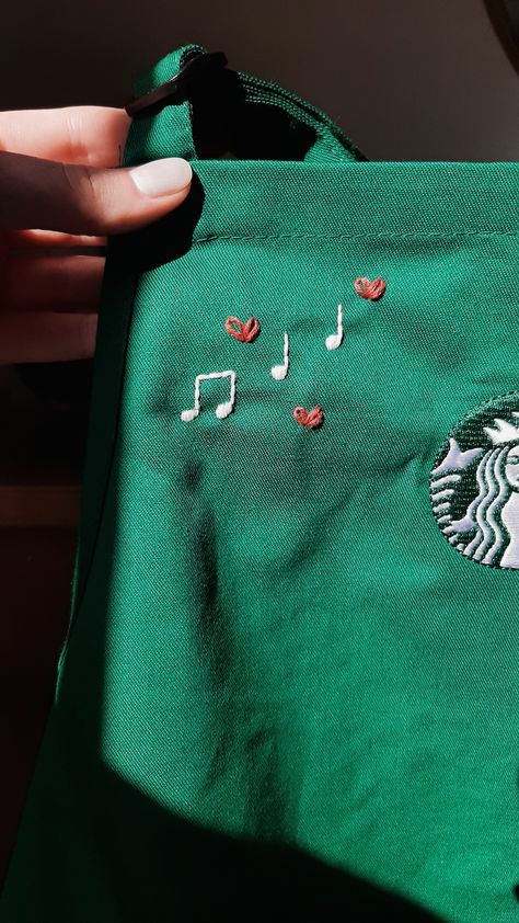 Customized Starbucks apron custom hand embroidery embroidered calligraphy simple minimalist tiny music notes design • jasper rose co Musical Notes Embroidery, Starbucks Apron Embroidery, Music Notes Embroidery, Embroidery On Apron, Tiny Embroidery Ideas Easy, Hand Embroidery Tshirt Ideas, Sweater Embroidery Ideas Simple, Music Embroidery Designs, Apron Embroidery Ideas