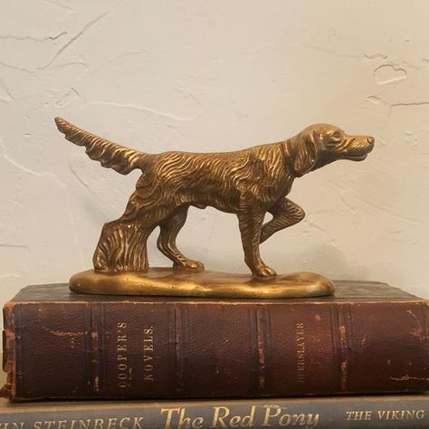 This unique antiqued brass pointer dog can be used as a paperweight or as tabletop decor. Makes an elegant addition to office, hunting cabin or lodge, or a great gift for an hunting or outdoors enthusiast.- 3-1/2" tall, 6" long base- Heavy, solid antiqued brass for a vintage look- Beautiful etched detailing Vintage Decor Office, Vintage Cabin Decor Living Room, Vintage Hunting Bedroom, English Hunting Lodge Decor, Hunting Lodge Bedroom, Vintage Hunting Nursery, Vintage Hunting Decor, Cabin House Decor, Antique Office Decor