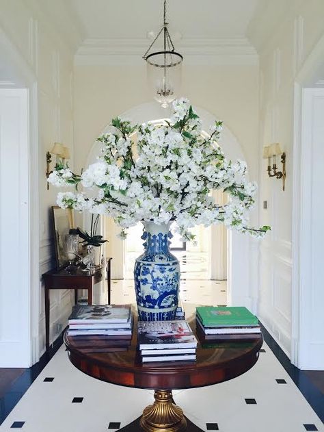 A tall porcelain vase is a great container for flowering branches. Tall Vase Decorating Ideas, White Vase With Flowers, Vase Decorating Ideas, Hall Ways Ideas, Orchid Centerpieces, Vase With Flowers, The Enchanted Home, Blue White Decor, White Interior Design