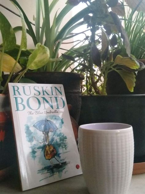 You'll finish the book before the rain stops but the story will continue to live with you. So short, simple yet touching. The Blue Umbrella By Ruskin Bond, The Blue Umbrella, Ruskin Bond, Blue Umbrella, Face Aesthetic, The Rain, Umbrella, The Story, Books