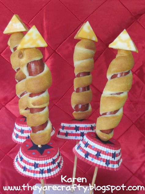 "Rocket Dogs" -  Put hotdog on a skewer, wrap dough strips around them, then bake on cookie sheet. Cut a triangle wedge of cheese for the top and slip a patriotic cupcake liner on the bottom. Space Snacks, Galaxy Party, Rocket Dogs, Patriotic Food, Space Explorer, Summer Foods, Fourth Of July Food, Patriotic Party, Belek