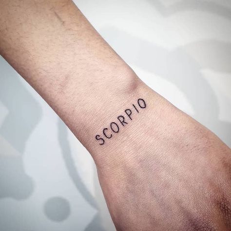 A letter tattoo for the minimalist Scorpios from @amaris.tattou- Stunning Scorpio tattoos for men Scorpio Word Tattoo, Scorpio Tattoo Men, Minimalist Tattoo Scorpio, Scorpio Tattoo Minimalist, Scorpion Hand Tattoo, Scorpio Tattoo For Men, Scorpio Sign Tattoos, Tattoo Scorpio, Brilliant Tattoo