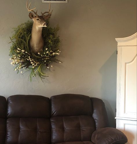 Added a wreath to husband’s deer head #deermount #husbandsdeerhead #taxidermy #wreath #deermountwithwreath #deermountdecor #deerheaddecor Taxidermy Decor Living Room Hunting, Wreath Around Deer Mount, Office With Deer Mounts, Boho Deer Head, Deer Head Above Fireplace, Tasteful Taxidermy Decor, Gallery Wall With Deer Mount, Decorating With Taxidermy, Deer Mount Wall Arrangement