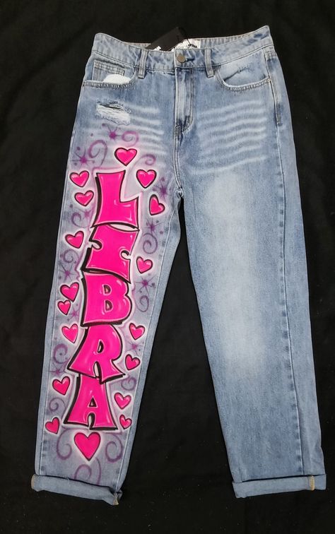 Artwork Only. You supply the jeans. I do not sell jeans. The jeans in the display image were provided by the customers. You may find the jeans with chains are from Fashion Nova. I do not stock the jeans with chains. I only airbrush the jeans you provide. I do not stock any jeans. Custom airbrushed 80's 90's style pointy graffiti lettering artwork on jeans you supply. The display designs are airbrushed in fluorescent and transparent colors for a hot intense look. This is for artwork only. I DO NOT SELL OR STOCK JEANS. We are always coming up with something new. Prices shown are the price of the One word name according to the number of letters in the name, with hearts, artwork shown in the photos. ARTWORK ONLY. Contact us for pricing on additional art and other great lettering styles. Jeans Air Brush Jeans, Custom Birthday Jeans, Zodiac Jeans, Airbrush Jeans, Airbrush Clothing, Birthday Jeans, Custom Birthday Outfits, Decorating Jeans, Hearts Artwork