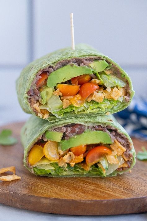 These Crunchy Black Bean Ranch Wraps are quick and easy to prepare and great for a healthy and hearty vegetarian lunch! They're filled with black refried beans, fresh tomato, pickled onion, creamy avocado, lettuce tossed with ranch and crunchy tortilla strips. They're packed with so much flavor and texture! #blackbeanwrap #vegetarian #mealprep #lunchrecipe Black Refried Beans, Vegetarian Mealprep, Ranch Wraps, Pickled Onion, Tortilla Strips, Vegetarian Lunch, Health Nut, Pickled Onions, Refried Beans