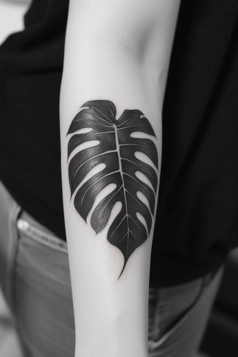 A captivating monstera leaf hand tattoo, featuring skillful shading, realistic lines, and a graceful design, exuding the charm of nature. This elegant design highlights the beauty of the monstera leaf, making it an ideal choice for those seeking a meaningful and artistic representation of their love for the natural world on their hand. Black Plant Tattoo, Big Leaf Tattoo, Black Leaf Tattoo, Black Leaves Tattoo, Leaf Hand Tattoo, Monstera Leaf Tattoo, Monstera Tattoo, Plant Tattoos, Tattoo Tree